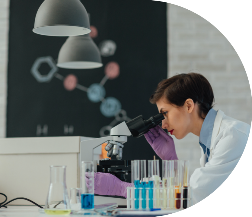 Woman in a laboratory looking into a microscope